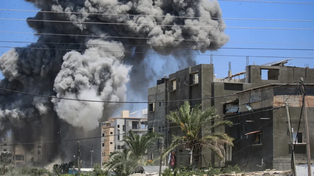 Smoke rises from a building hit by an Israeli strike