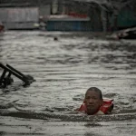 Floods inundate Philippine capital, oil tanker sinks as deadly typhoon prompts calls for climate action