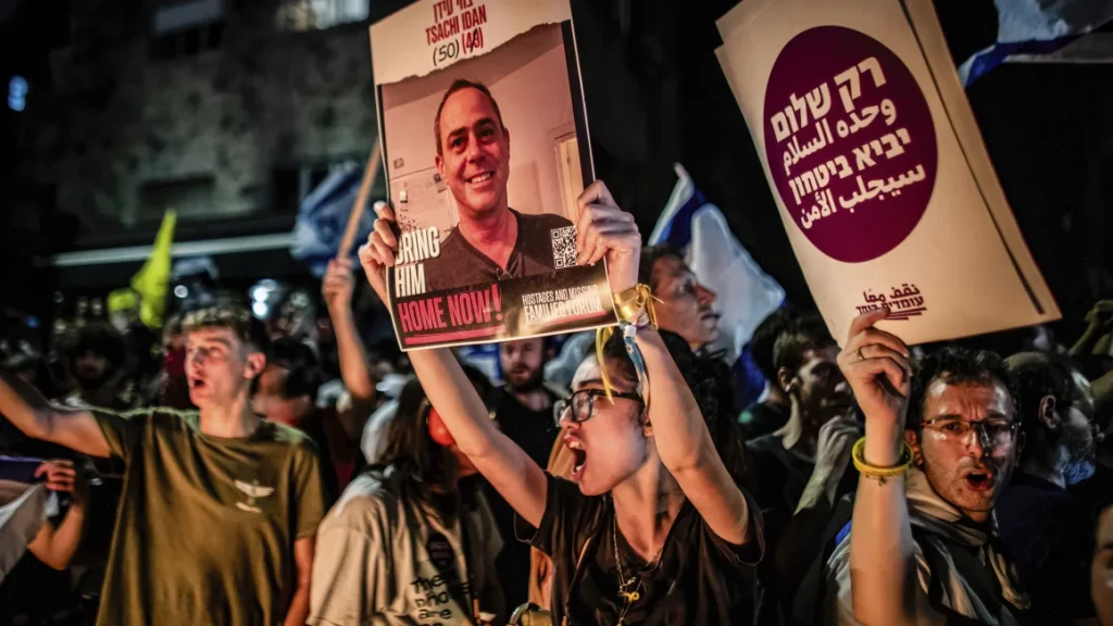 A protester holds up a photo of Tsachi Idan