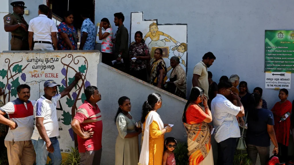 Voters line up outside a polling station to vote in the presidential election